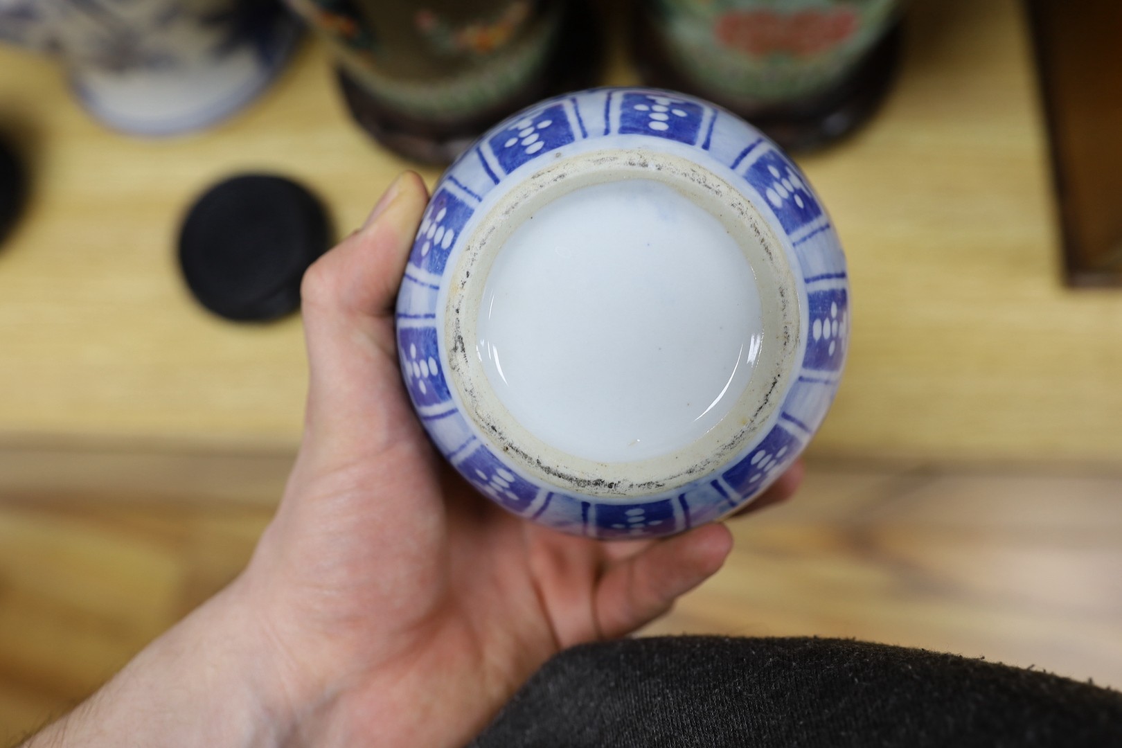 A pair of Japanese black ground vases, a pair of Chinese blue and white vases and covers, a similar pair of jars and a vase, four wood stands. Largest 41cm